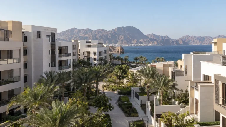 Modern residential development in Oman with mountains and sea